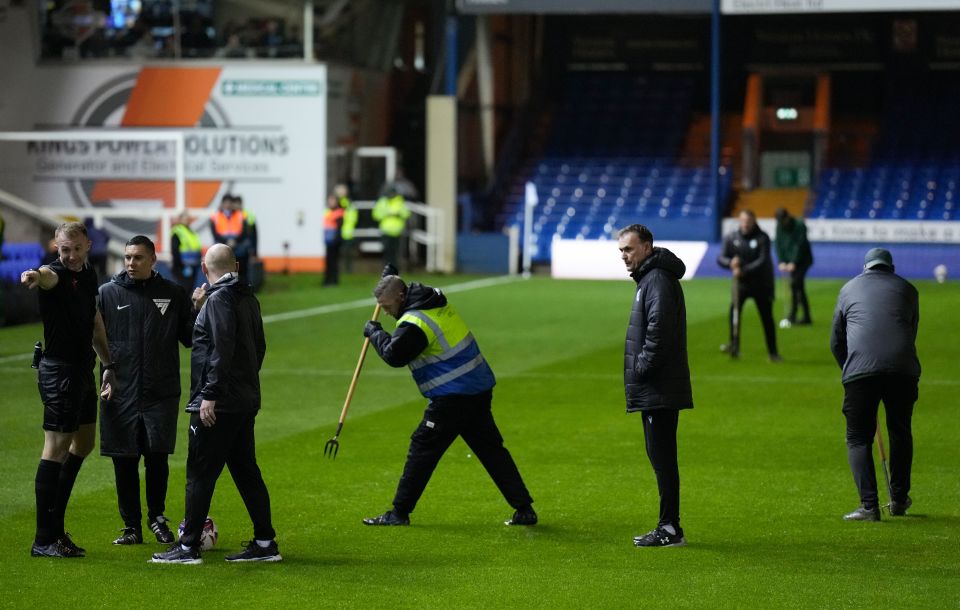 men on a soccer field with a sign that says kings power solutions