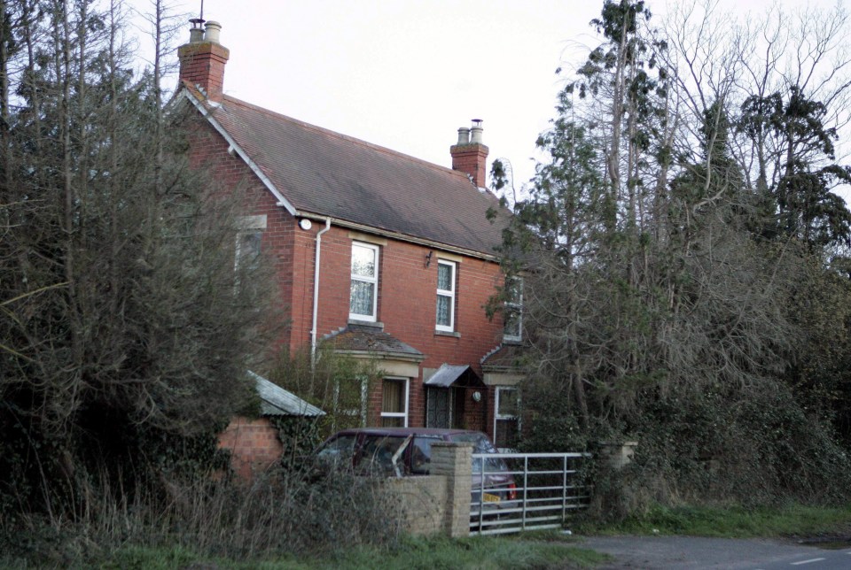 a brick house with a car parked in front of it