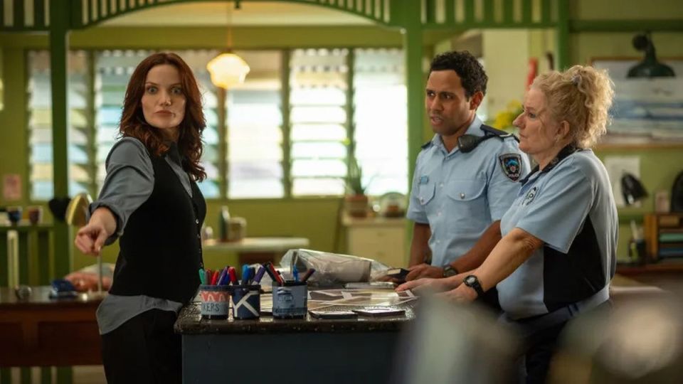 a group of police officers are standing around a counter