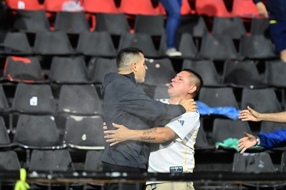 Juan Roman Riquelme (left) was seen getting between ultras and police as chaos erupted at a Copa Argentina game