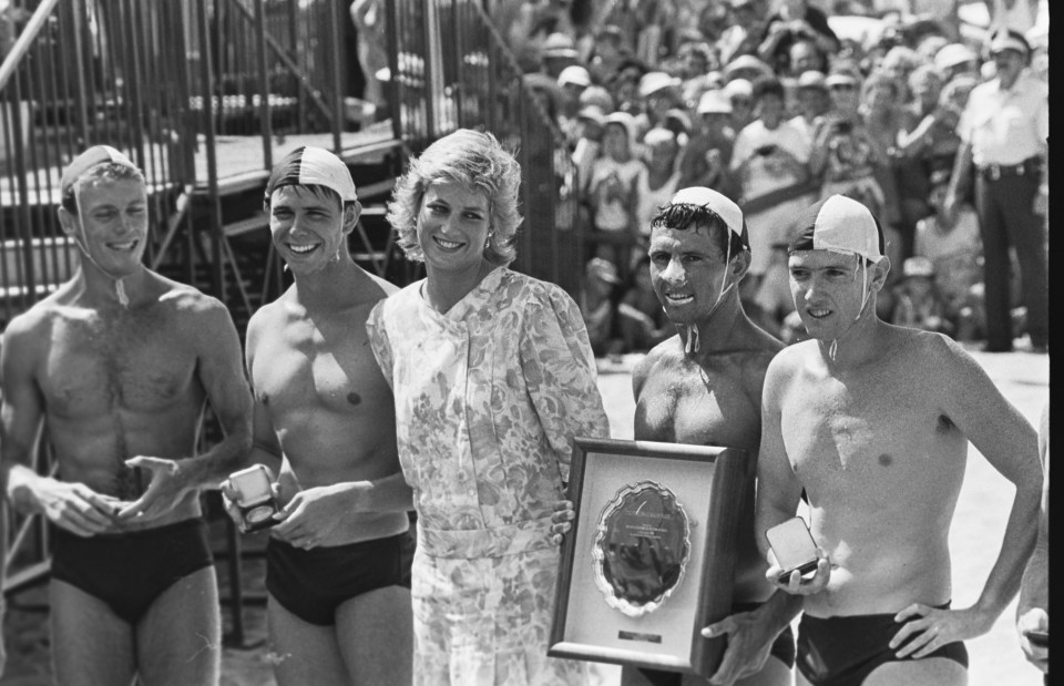 a black and white photo of a woman holding a plaque