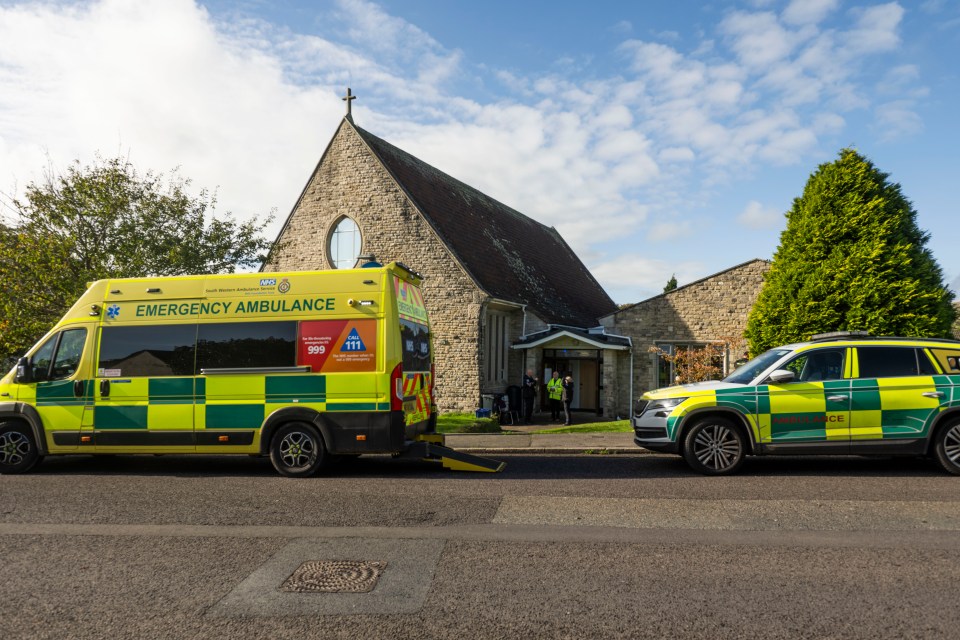 an emergency ambulance is parked in front of a church