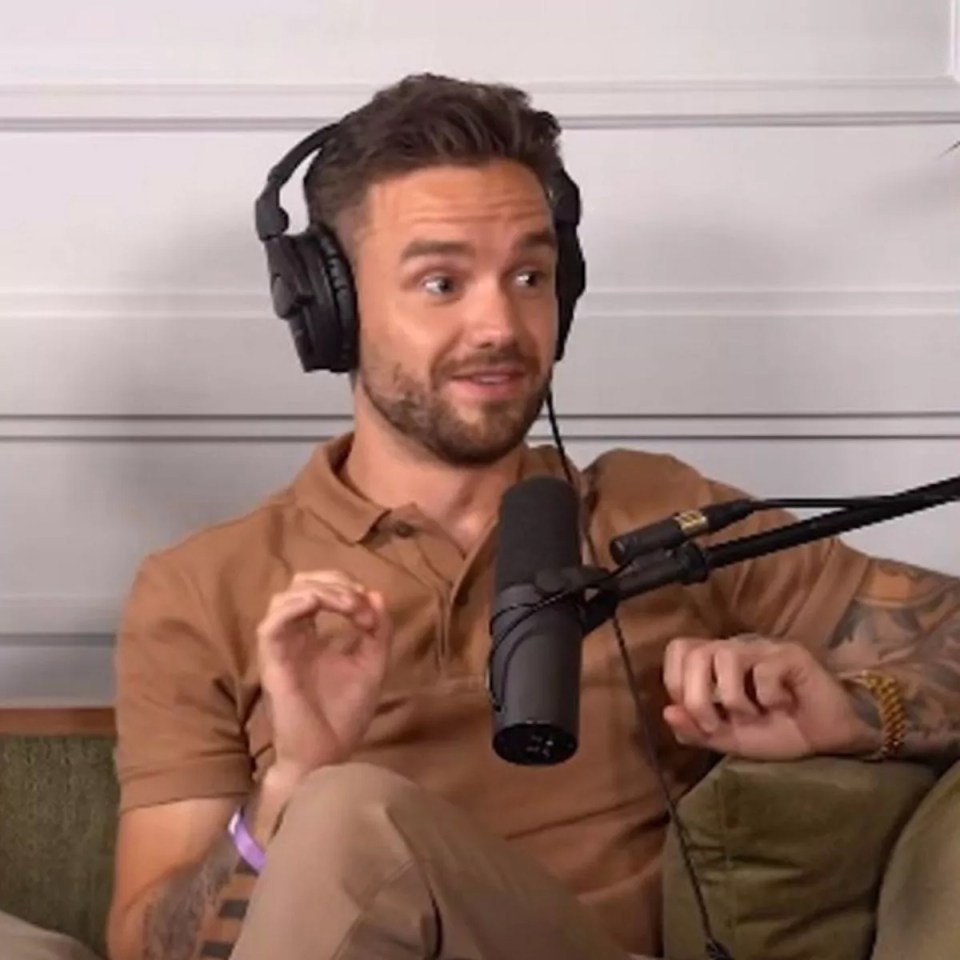 a man wearing headphones is sitting in front of a microphone