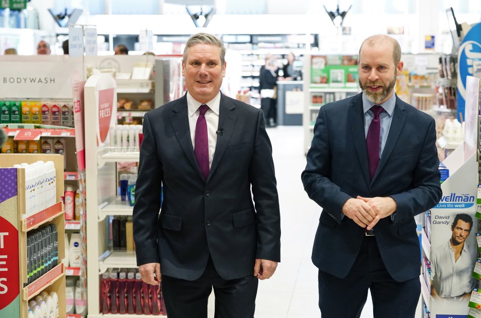 two men standing in a store with a sign that says bodywash