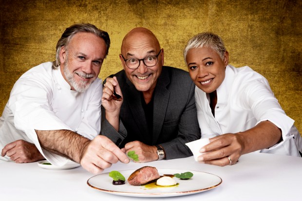 three people are posing for a picture in front of a plate of food