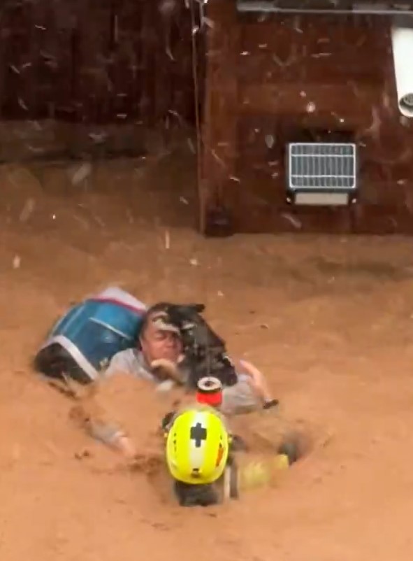 The dog owner struggled to swim as the floodwater kept flowing ruthlessly