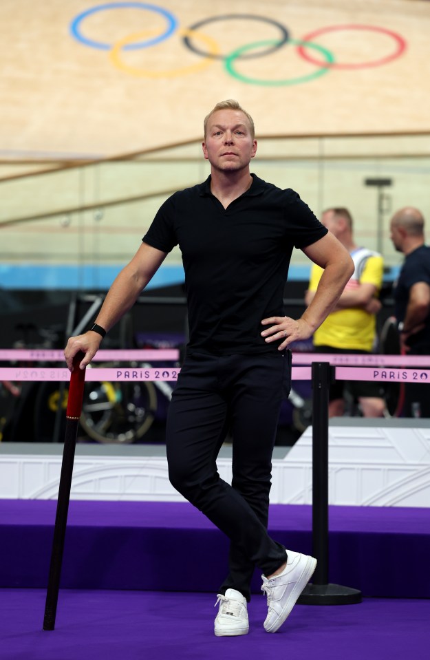 a man stands in front of a paris sign