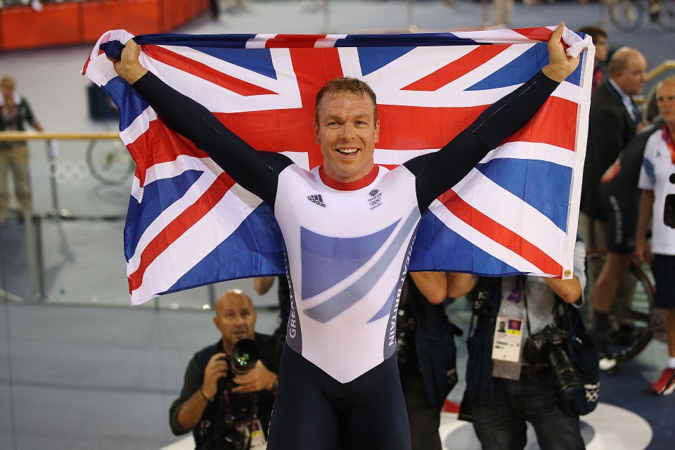 a man holding a british flag in his hands