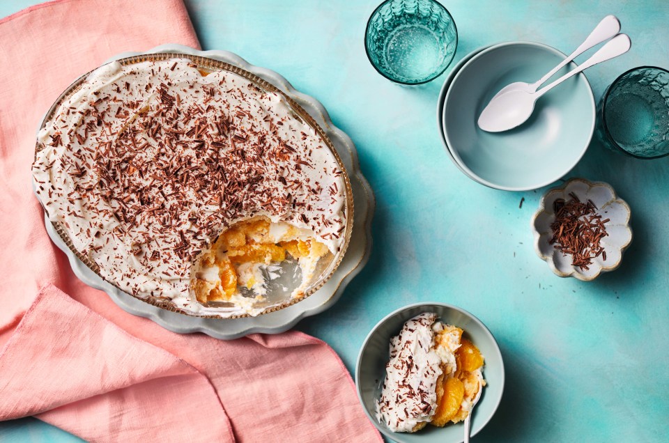 a pie with whipped cream and chocolate shavings on top