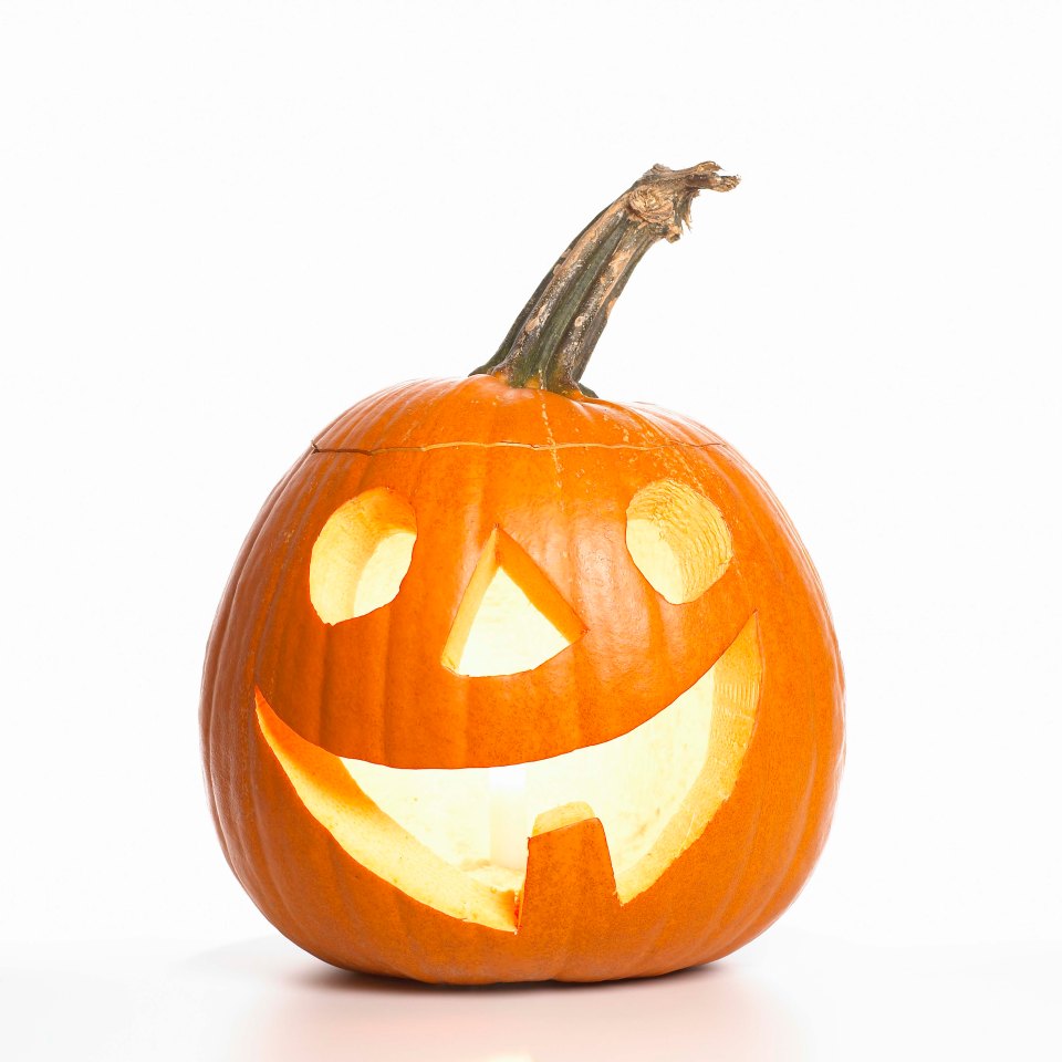 a halloween pumpkin with a smiling face carved into it