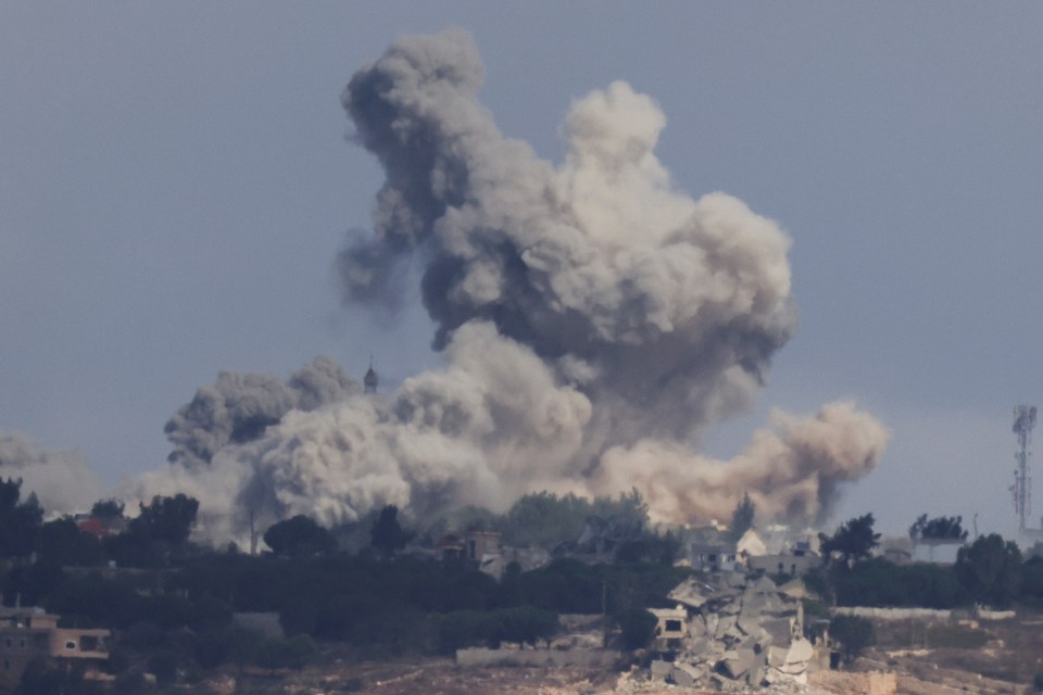 a large cloud of smoke is coming out of a building