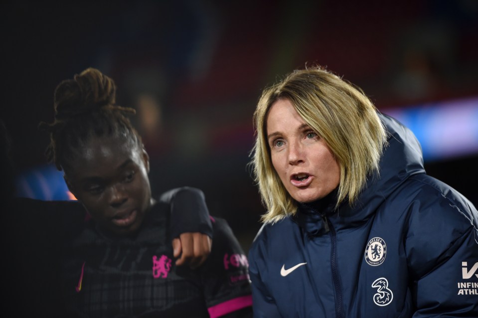 a woman wearing a chelsea jacket talks to another woman