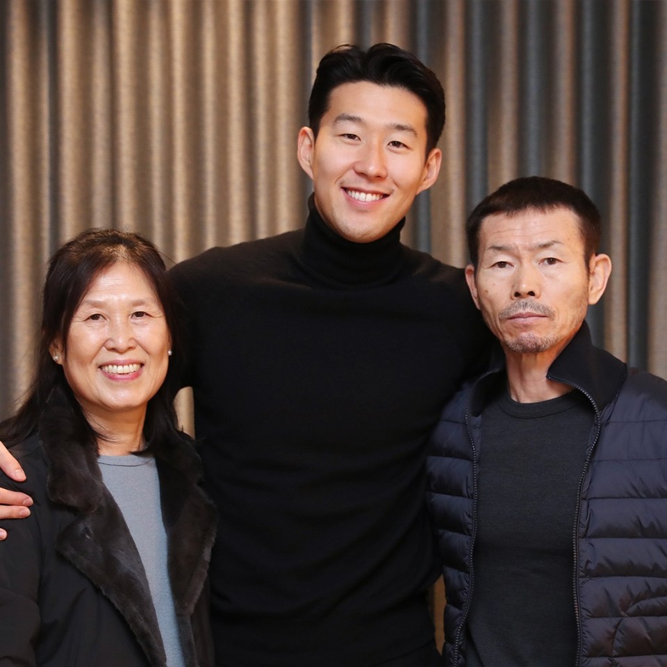 a man and two women pose for a picture together