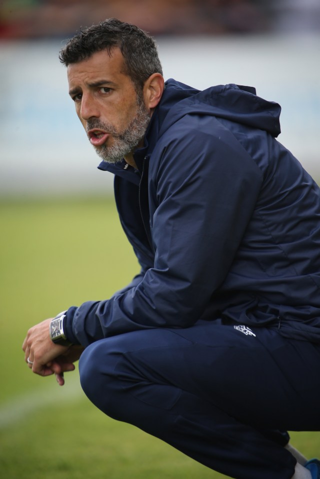 a man wearing a blue jacket with the word adidas on it