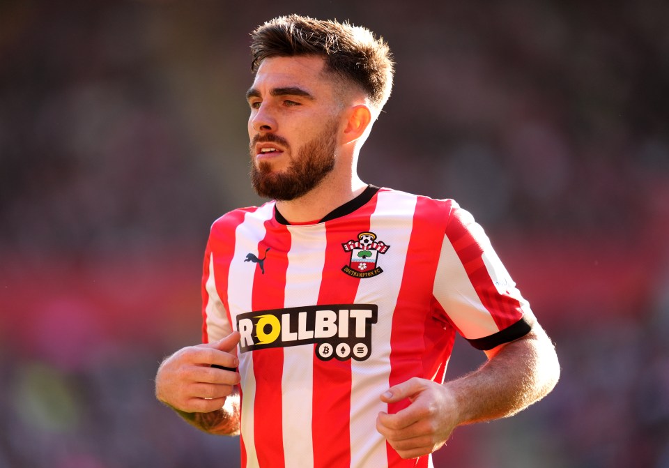 a soccer player wearing a red and white striped jersey that says rollbit