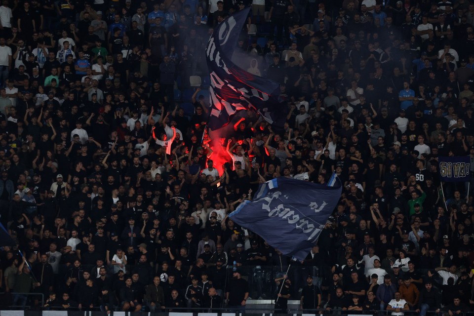 a crowd of people in a stadium with a banner that says 50 on it