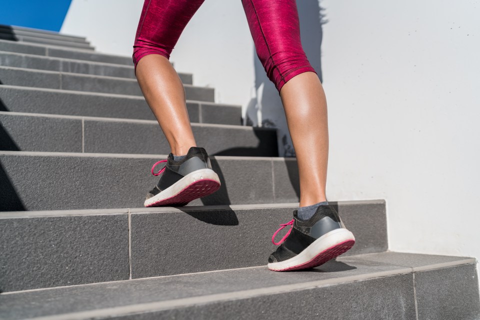 a woman is walking up a set of stairs