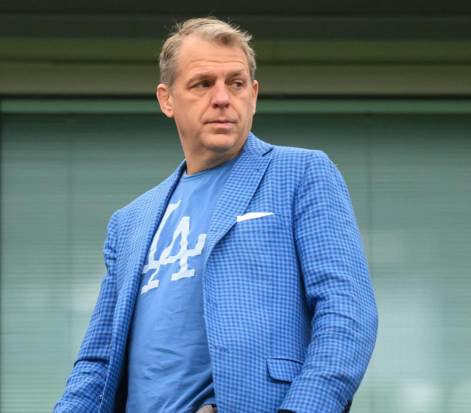 a man wearing a la shirt and a blue jacket