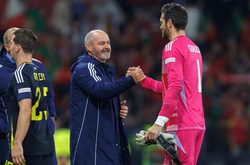 a soccer player with the number 1 on his jersey shakes hands with another player