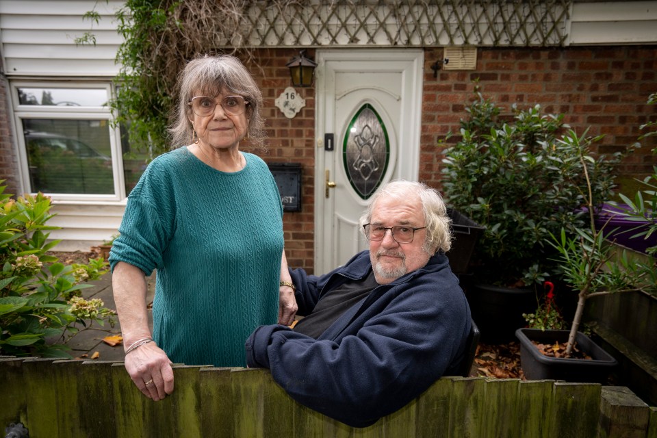 a man and a woman standing in front of a house with the number 7 on the door