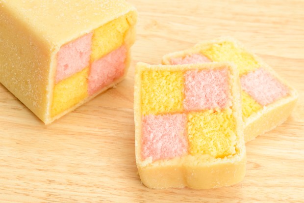 a piece of cake with yellow and pink squares on it