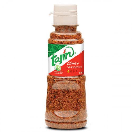 a bottle of tajin clasico seasoning on a white background .