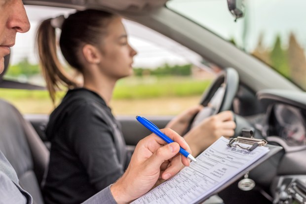 a woman in a car is taking a driving test