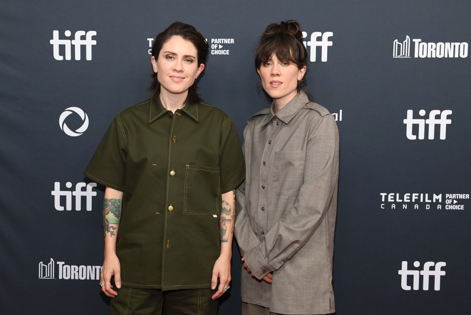 two women standing in front of a tiff banner