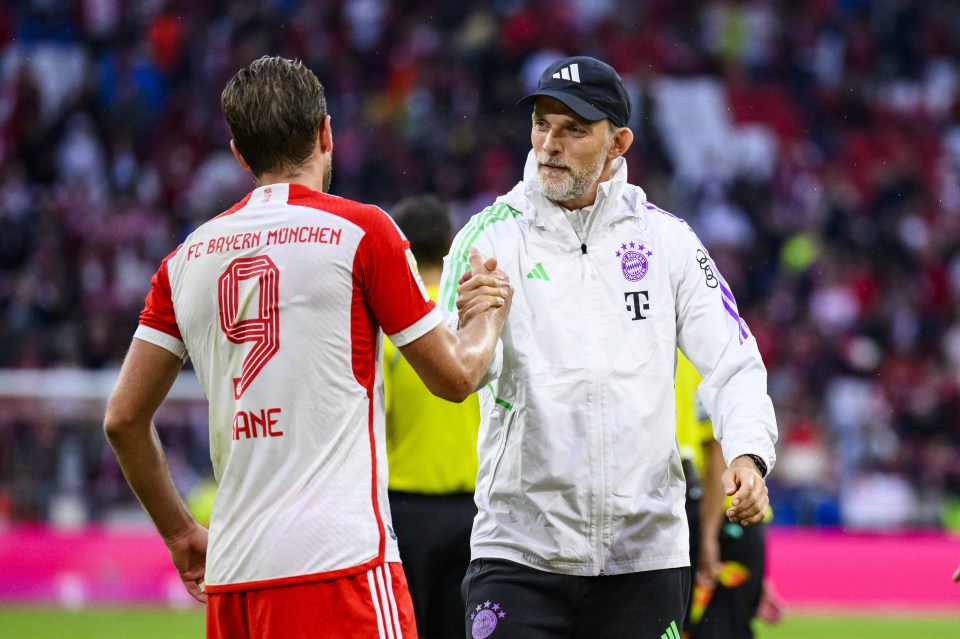 a soccer player with the number 9 on his jersey shakes hands with another player