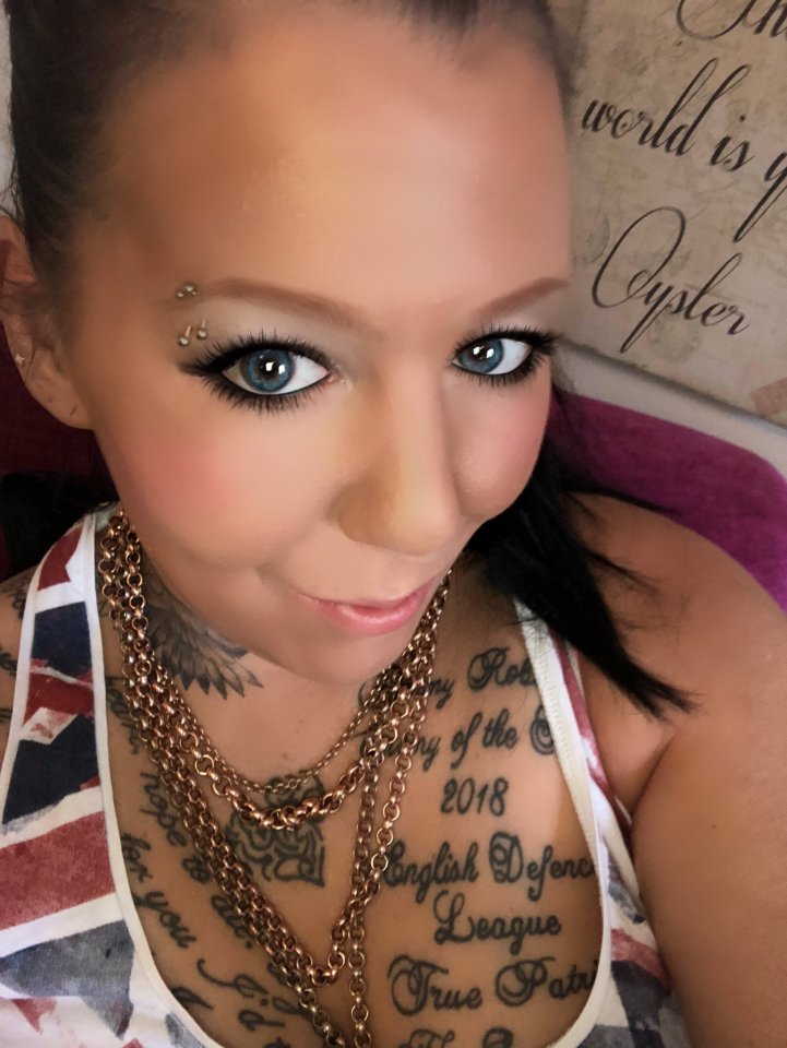 a woman with a tattoo on her chest that says english defense league