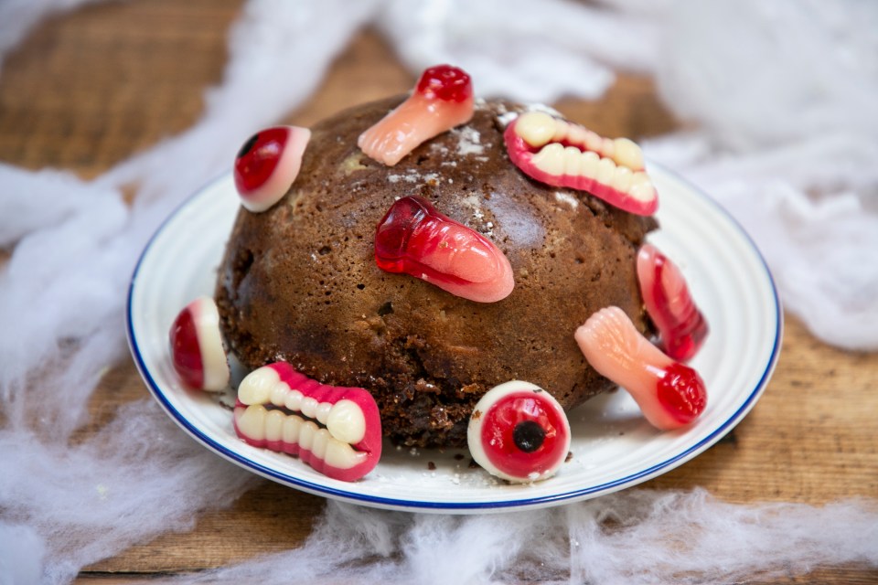 a chocolate cake with gummy teeth and eyes on it