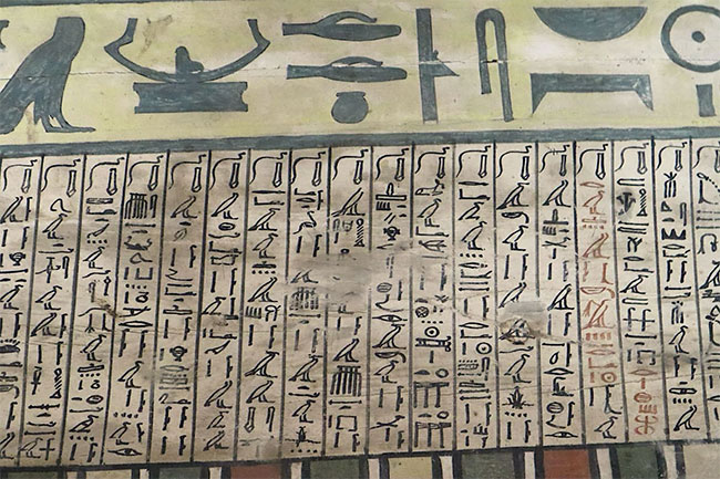 The coffins have painted text about the journey to the afterlife