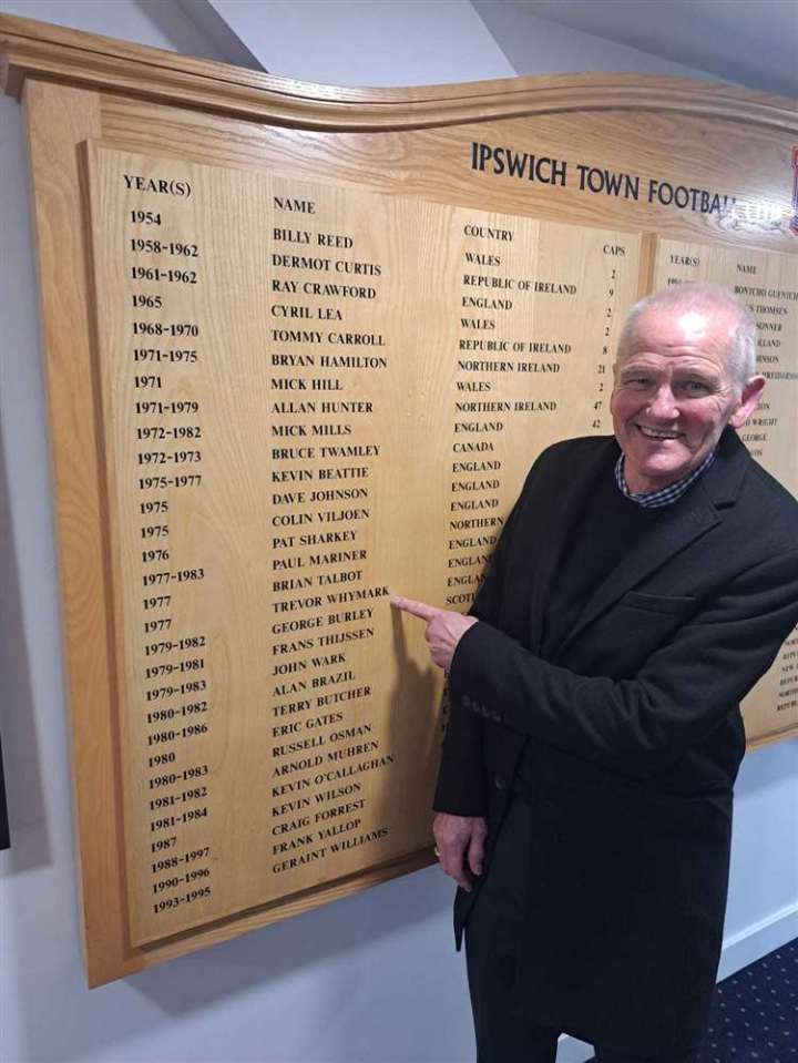 a man points to a list of ipswich town footballers