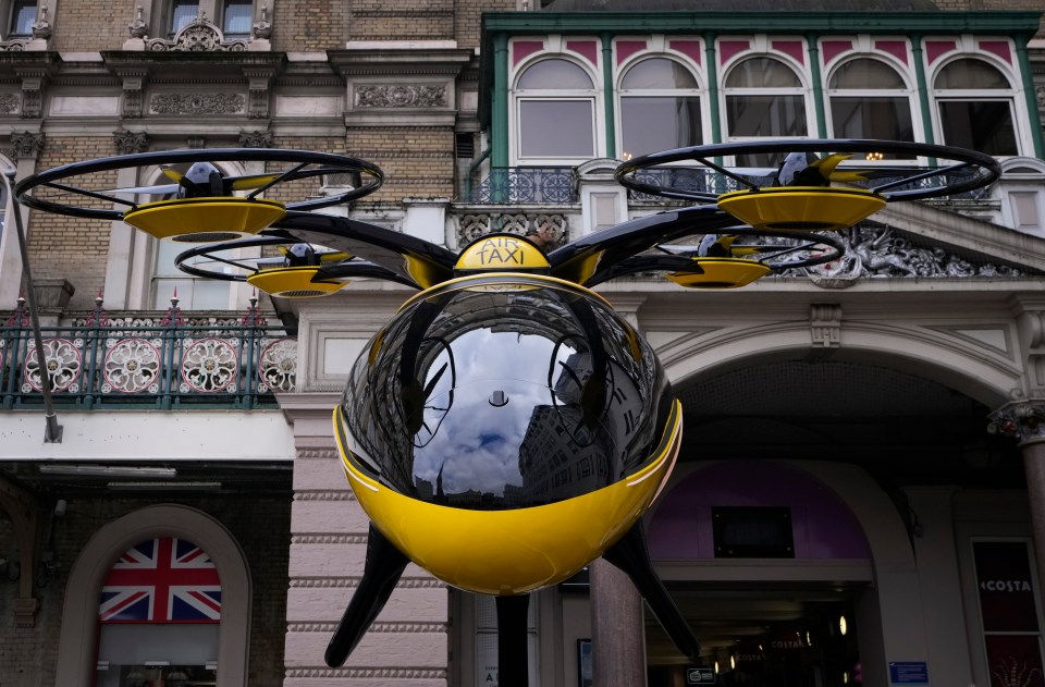 a flying taxi is displayed in front of a building