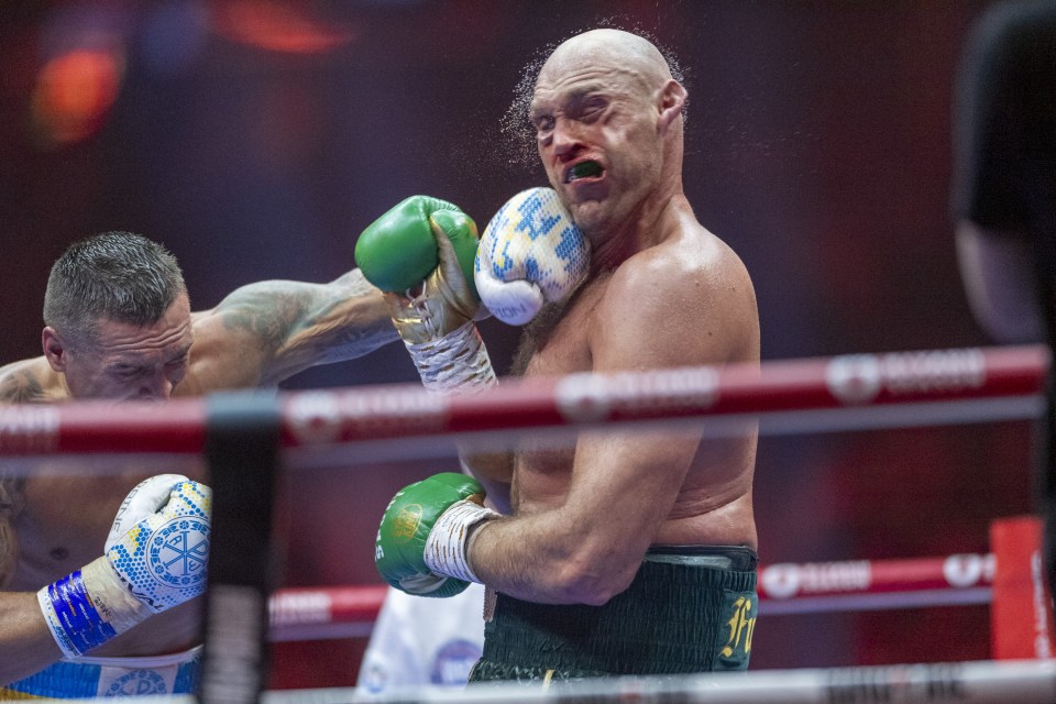 a man wearing green boxing gloves with the word king on them