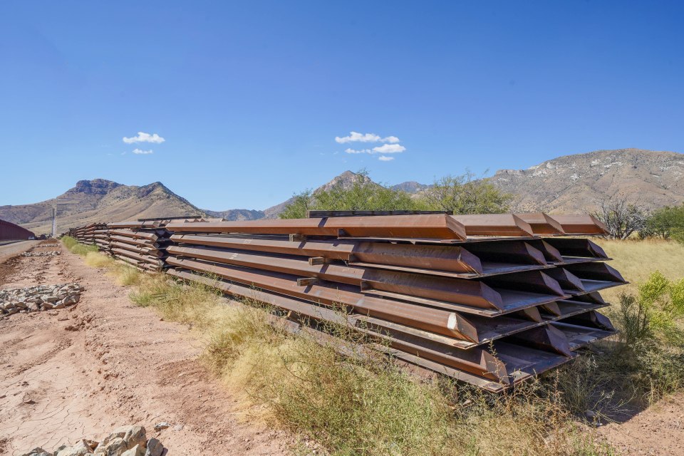 Abandoned metal fence posts after wall construction was cancelled