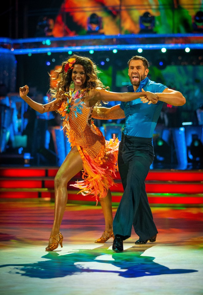 a man and a woman are dancing on a stage