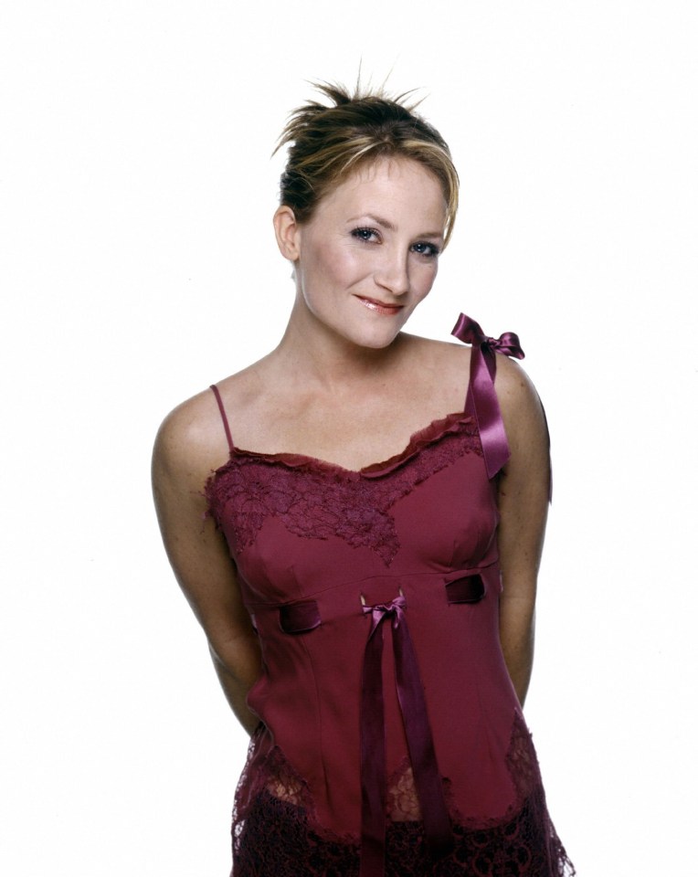 a woman in a purple top with a bow on the shoulder