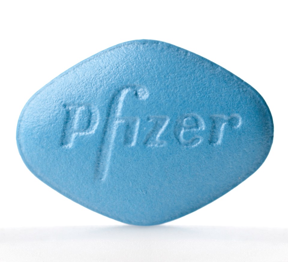 a blue pfizer pill on a white background