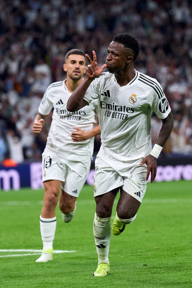 two soccer players wearing emirates fly better jerseys celebrate