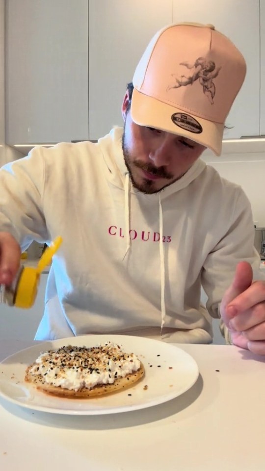 He added cottage cheese to crackers and made sure it was well seasoned