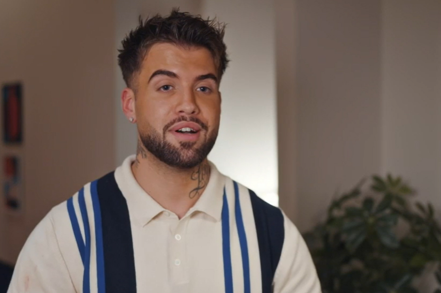 a man with a beard is wearing a striped shirt