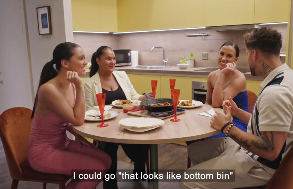 a group of people sitting around a table with a man saying " i could go that looks like bottom bin "