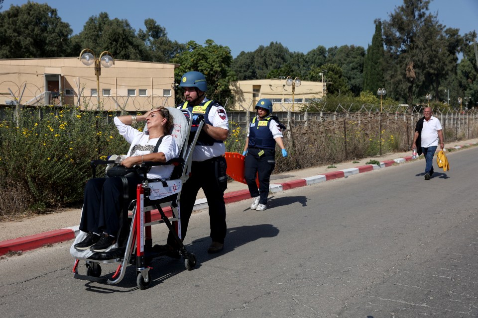 A woman is evacuated from the scene