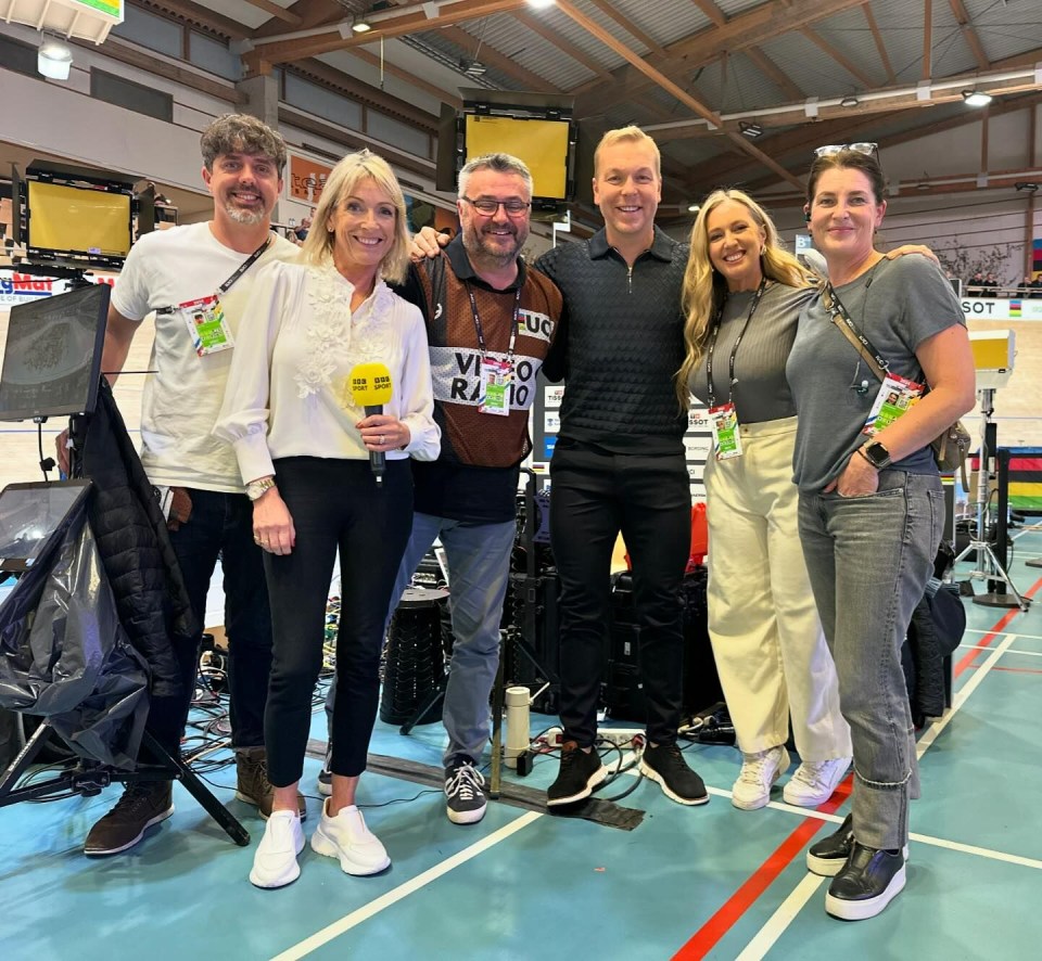 a group of people posing for a picture with one wearing a lanyard that says video radio