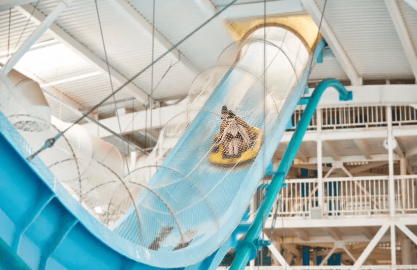 a person riding a tube down a water slide