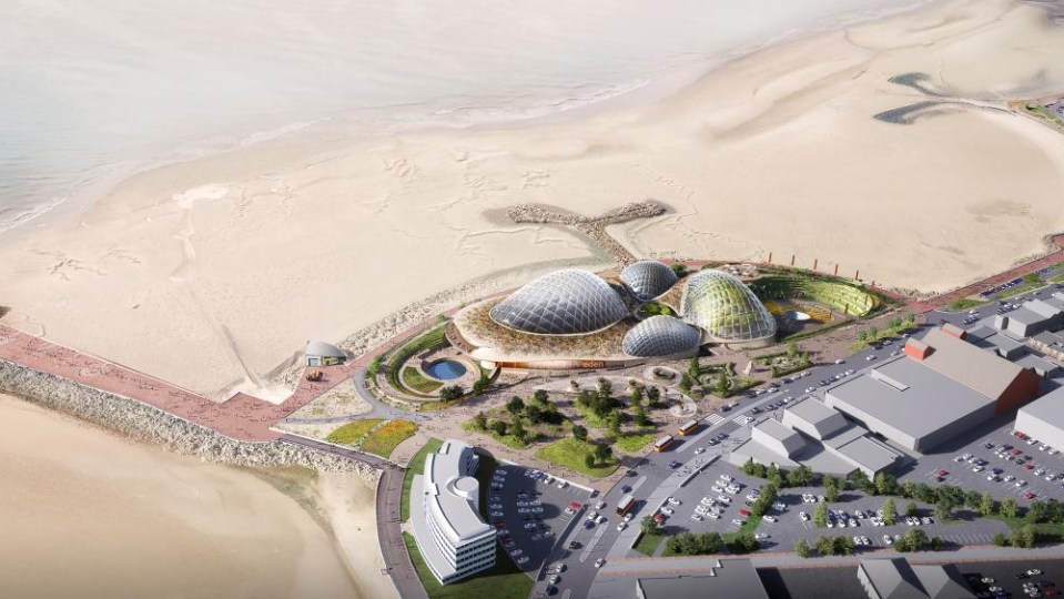 an aerial view of a large building on a beach