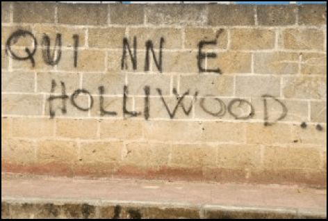 a brick wall has the word hollywood spray painted on it