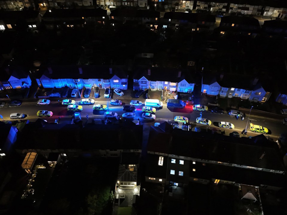 Large numbers of police cars and ambulances at the scene