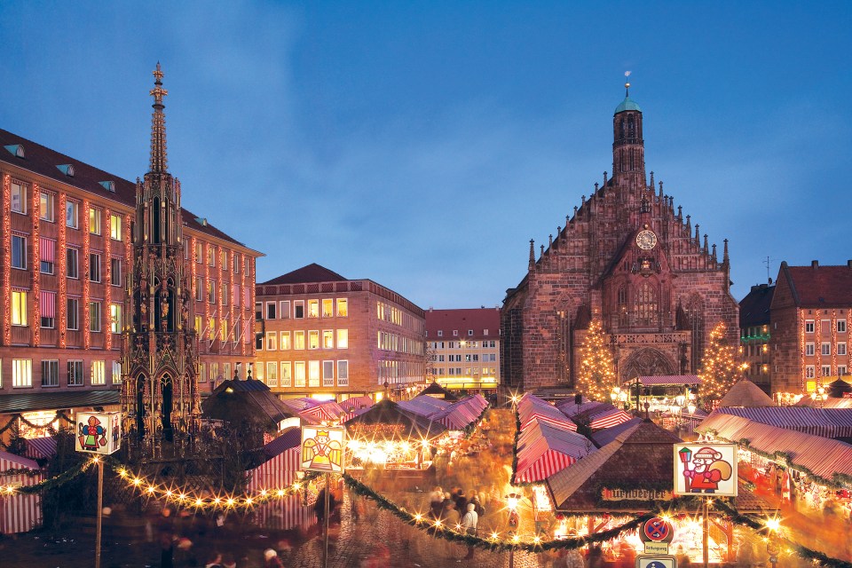 a christmas market in front of a church with a sign that says no parking